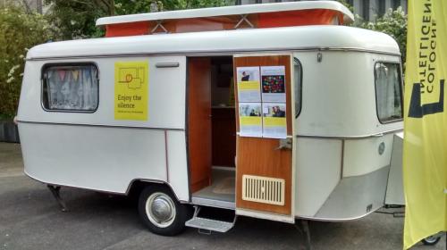 An old camping trailer in the yard, marked as \